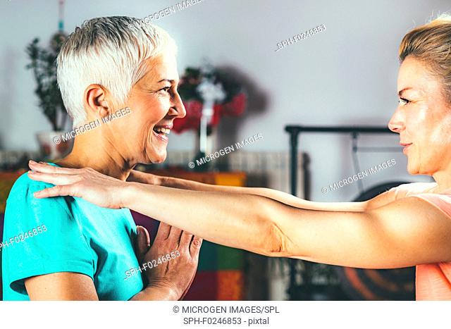 Senior woman in private yoga class