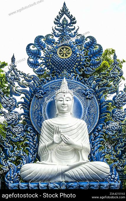 White buddha at the Blue Temple (Wat Rong Suea Ten or Temple of the Dancing Tiger) in Chiang Rai, Thailand, Asia. Blue is symbolically associated with purity