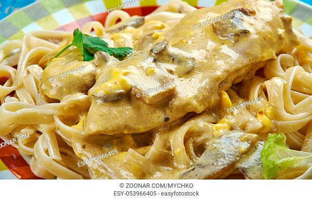 Creamy Tuscan Garlic Chicken - juicy crusted chicken served over noodles with a delicious creamy tuscan garlic sauce