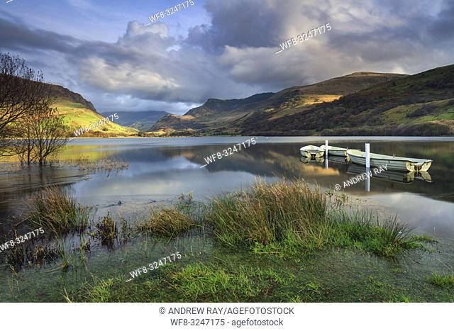 Boats on Llyn Nantlle in the Snowdonia National Park with Snowdon, the highest mountain in Wales in the distance