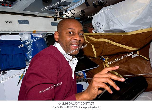Astronaut Robert L. Satcher Jr., STS-129 mission specialist, works on the middeck of Space Shuttle Atlantis during flight day two activities