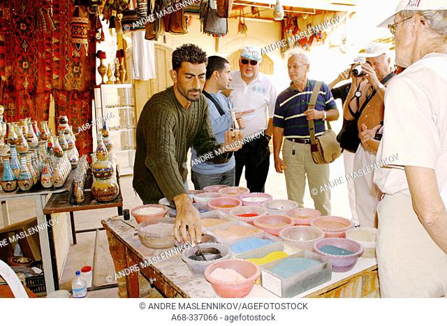 Making souvenirs with colored sand in glass bottles. Jerash. Jordan