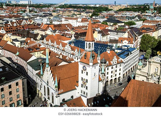 Beautiful super wide-angle sunny aerial view of Munich, Bayern, Bavaria, Germany with skyline and scenery beyond the city, seen from the observation deck of St