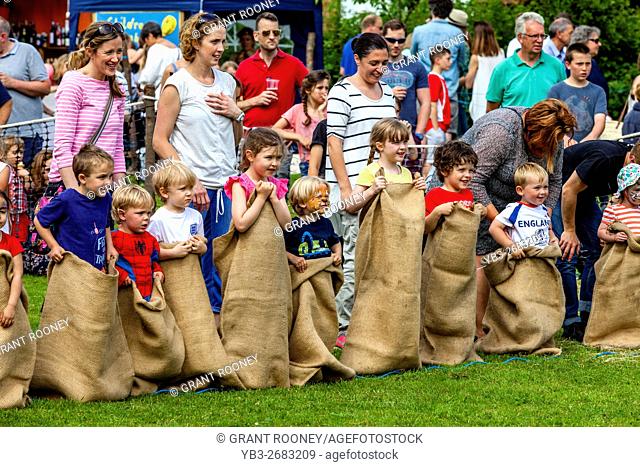 Children Prepare To Race In A Traditional Sack Race At The Medieval Fair Of Abinger, Surrey, UK