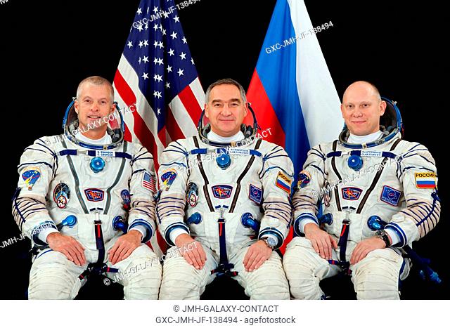 NASA astronaut Steve Swanson (left), Expedition 39 flight engineer and Expedition 40 commander; along with Russian cosmonauts Alexander Skvortsov (center) and...