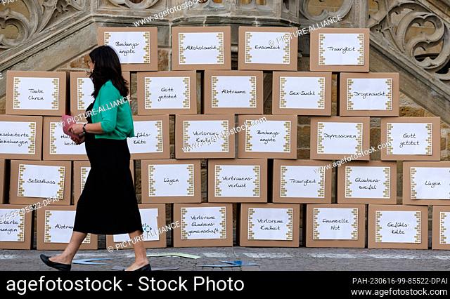 16 June 2023, Lower Saxony, Osnabrück: A woman walks along a ""Wailing Wall"" at a vigil on the eve of the Ecumenical Church Day