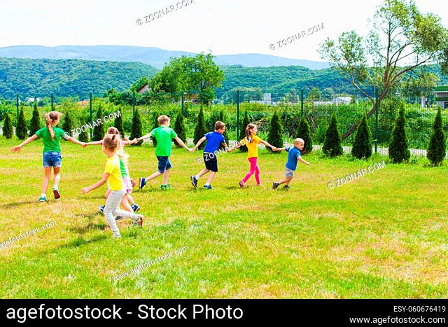 Outdoor game snake. Children run holding hands and collect each others