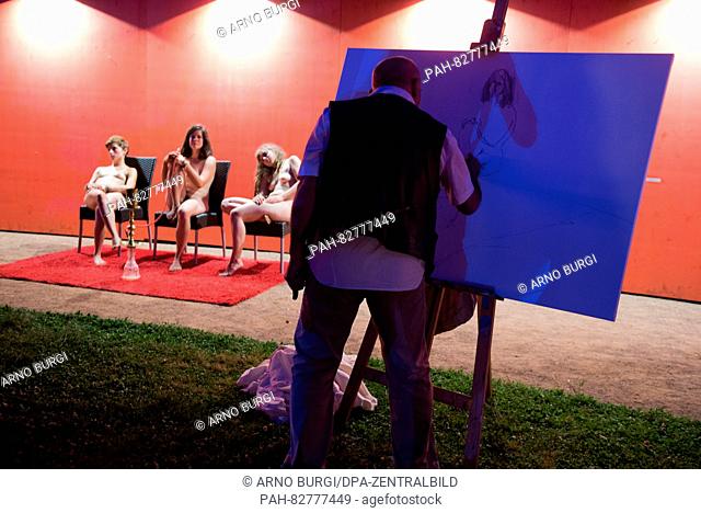 Three nude models sit at for the artists on chairs the first 'Nachtaktmalerei' (lt. Night Nude painting ) in front of the Japanese Palace in Dresden, Germany