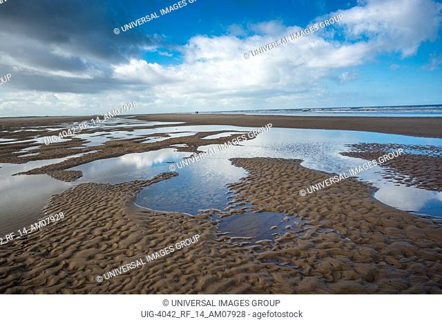 Patterns made by tide pools of water at low tide on Barnham Overy Staithe beach on Holkham bay, North Norfolk coast, East Anglia, England, UK