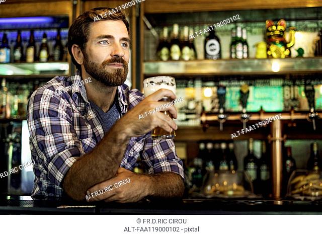 Man holding beer glass