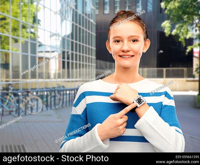teenage girl showing smart watch with qr code