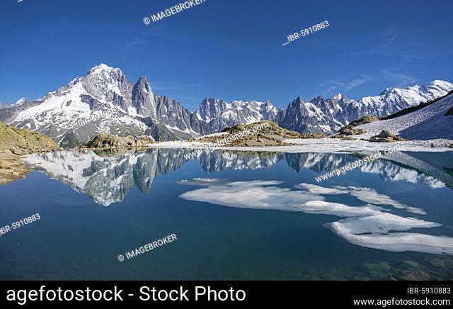 Mountain panorama, ice floe on Lac Blanc, mountain peaks reflected in mountain lake, Grandes Jorasses and Mont Blanc massif, Chamonix-Mont-Blanc, Haute-Savoie