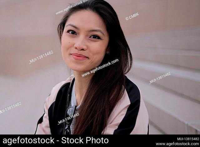 Young Asian woman in a city - people photography
