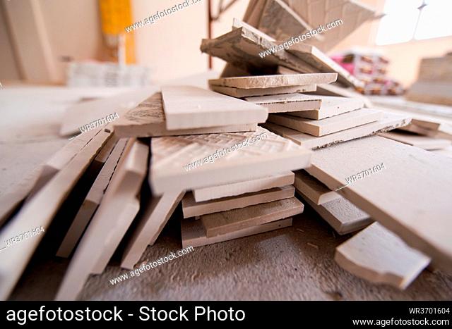 pile of the ceramic wood effect tiles on the floor laminate flooring on the construction site of the new apartment