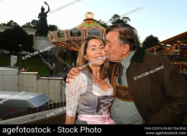 17 September 2022, Bavaria, Munich: Businessman Richard Lugner kisses his companion Andrea on the balcony of the Käfer tent at the start of the 187th Munich...