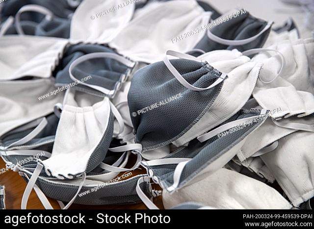 23 March 2020, Bavaria, Würzburg: Mouth masks, made from production materials of a mattress, lie on a table in the production of the foam manufacturer Wegerich