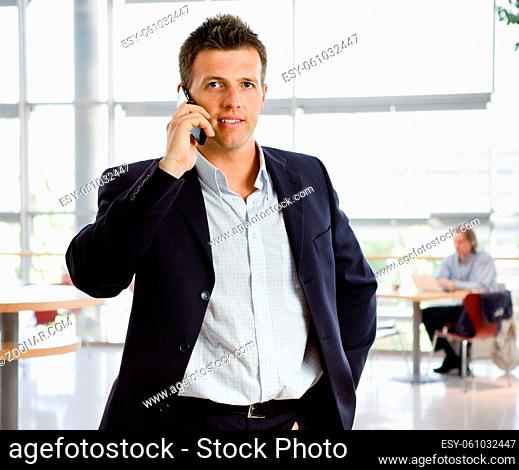 Happy businessman calling on mobile phone