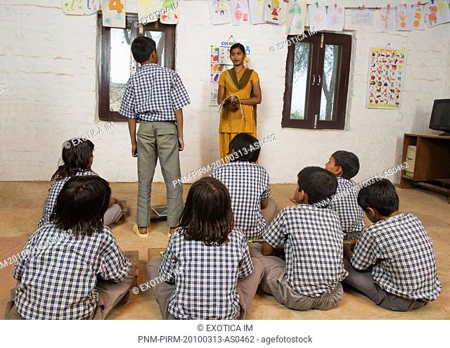Woman teaching students in a classroom