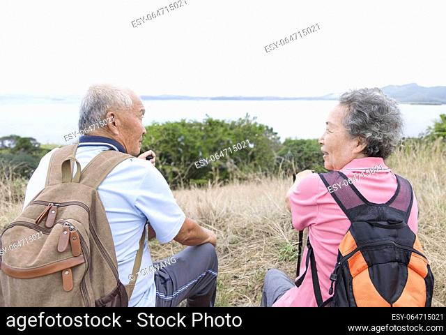Happy Senior couple hiking on the mountains