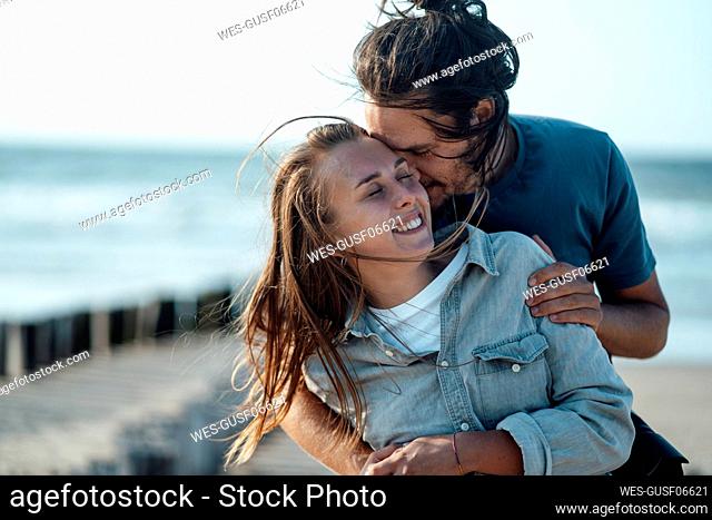 Affectionate couple embracing at beach