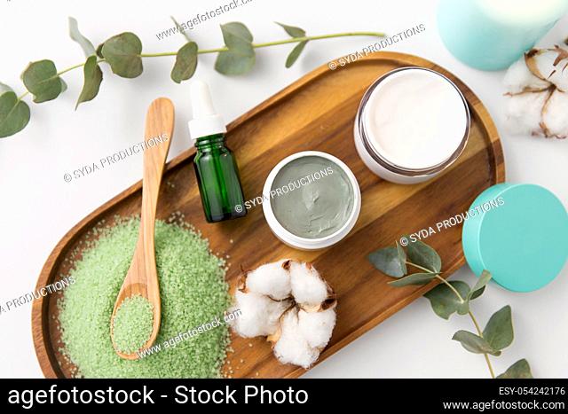 bath salt, serum, moisturizer and oil on tray