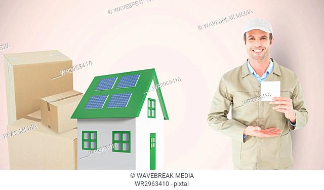 Delivery man holding card by 3d house and parcels