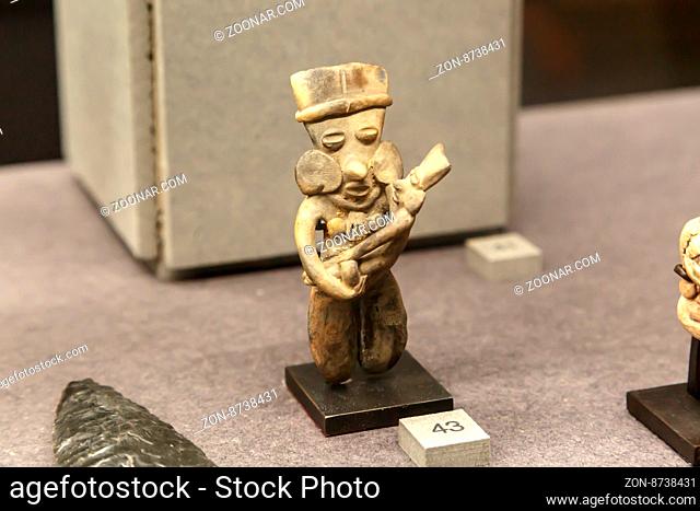 FLORENCE, ITALY - SEPTEMBER 20, 2015 : Close up detailed view of small basaltic olmec figurine exhibited in Florence Archeology Museum