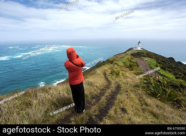 Guy infront of Cape Reinga Lighthouse, Cape Reinga, Te Rerenga Wairua, Northland, North Island, New Zealand, Oceania