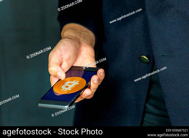 Cryptocurrency Bitcoin coin on a smartphone wallet