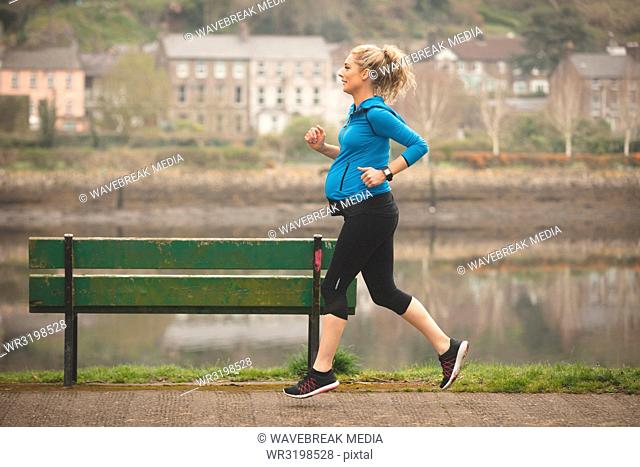 Pregnant woman jogging in the park