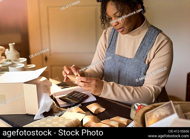 Female shop owner preparing boxes for shipping