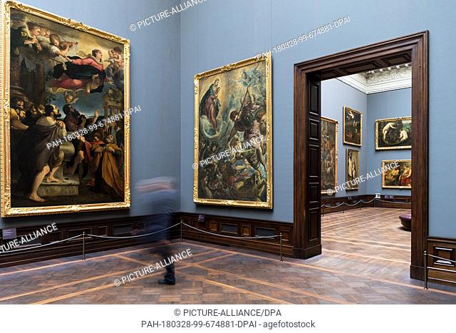 28 March 2018, Germany, Dresden: A man walking past the painting 'Die Himmelfahrt Mariae' (lit. the ascension of Mary) in the Old Masters Picture Gallery from...