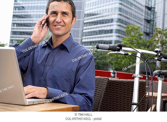 Man working on laptop outside