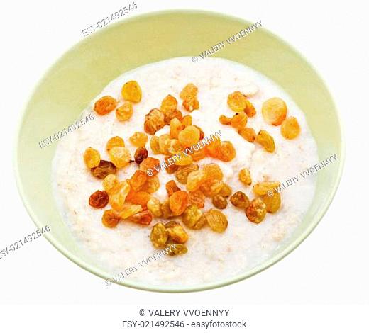 oat porridge with raisins in yellow bowl