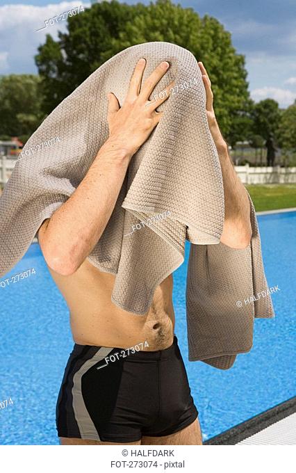 A man drying himself off after swimming