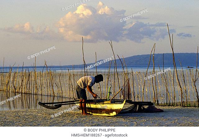 Philippines, Visayas Archipelago, Bohol Island, fisherman with an outrigger canoe on beach