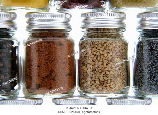 Glass flasks with assorted spices detail