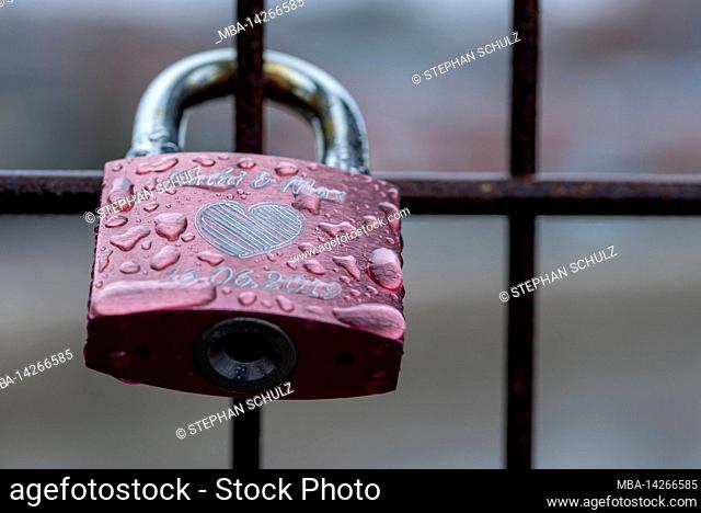 A love lock hangs on a bridge
