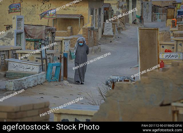 12 November 2020, Iraq, Najaf: A man walks through Wadi al-Salam (Valley of Peace) cemetery in the Shiite holy city of Najaf