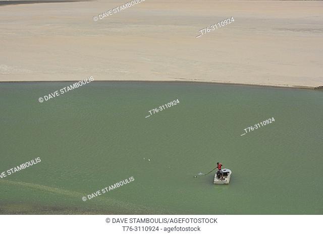 Fisherman on emerald Lake Yashilkul, Pamir Highway, Tajikistan