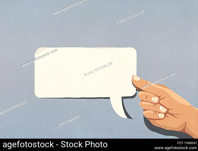 Hand holding blank speech bubble