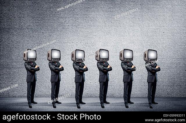 Businessmen in suits with old TV instead of their heads keeping arms crossed while standing in a row in empty room