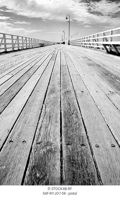 Empty wooden walkway by the seaside