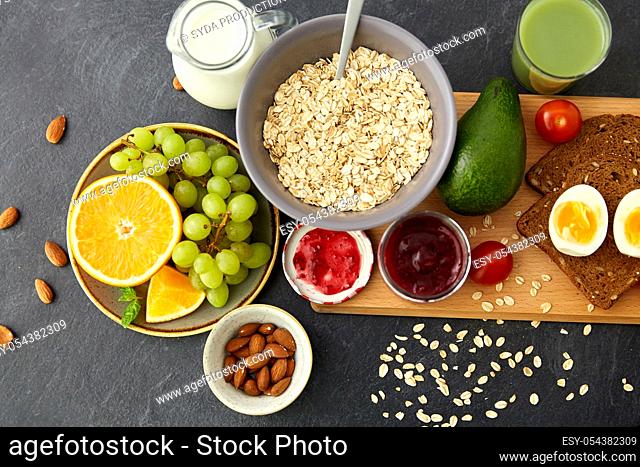oatmeal, fruits, toast bread, egg, jam and milk