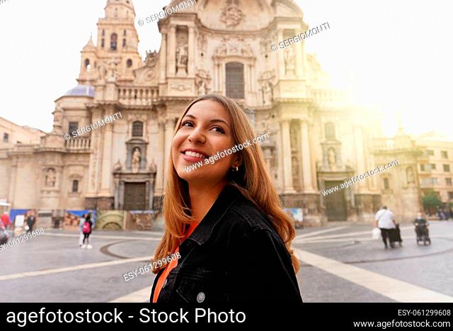 Tourist girl visiting Murcia with the Cathedral Church of Saint Mary on the background, Murcia, Spain