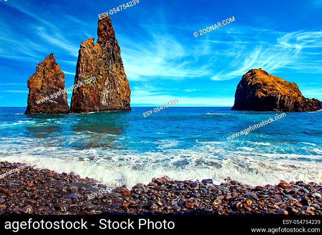 Three huge scenic rocks near the pebble beach. Magic travel on the volcanic island of Madeira. Concept of exotic and ecological tourism