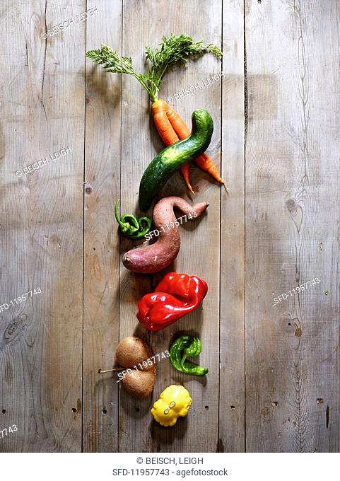 Wonky vegetables on a wooden surface