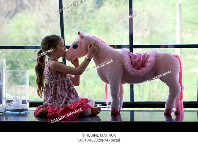 Girl with toy horse