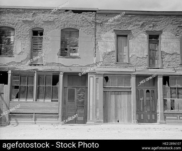Crumbling buildings in Tombstone, Arizona, once a thriving mining town, 1937. Creator: Dorothea Lange