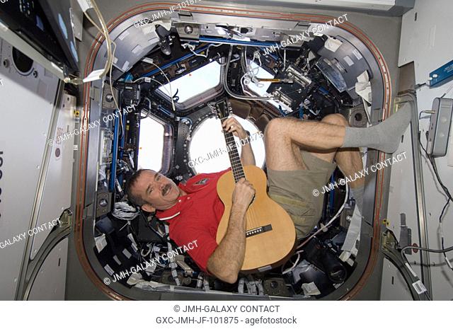 Canadian Space Agency astronaut Chris Hadfield strums his guitar in the International Space Station's Cupola on Dec. 25, 2012